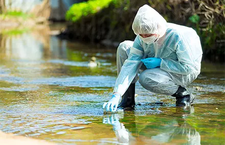 Man taking water samples from a river